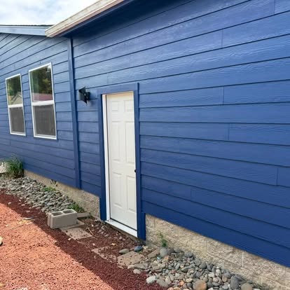 Rich blue lap siding, weather barrier and clean door trim